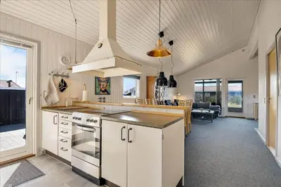 a kitchen with white cabinets and a stove at 100-Harboore-Vejlby-Klit-51 in Harboør