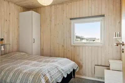 a bedroom with a bed and a window at 259-Harboore-Vejlby-Klit-129 in Harboør
