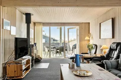 a living room with a television and a table at 259-Harboore-Vejlby-Klit-129 in Harboør