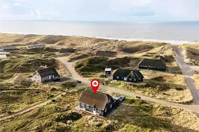 a group of houses on a hill near the ocean at 242-Harboore-Doblervej-81 in Harboør