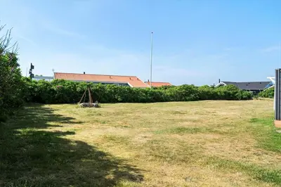 a yard with a fence and a swing at 212-Harboore-Neerlandiavej-62 in Harboør
