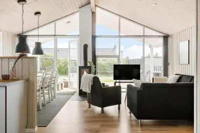 a living room with a couch and a tv at 212-Harboore-Neerlandiavej-62 in Harboør