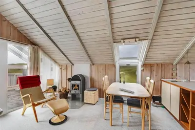 a kitchen and dining room with a table and chairs at 108-Harboore-Merchantvej-10-C in Harboør