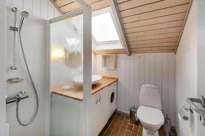 a bathroom with a toilet and a sink and a shower at 108-Harboore-Merchantvej-10-C in Harboør