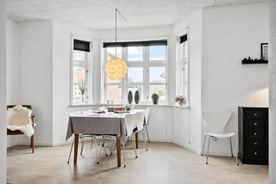 a white dining room with a table and chairs at 713-Thyboron-Vesterhavsgade-34 in Thyborøn