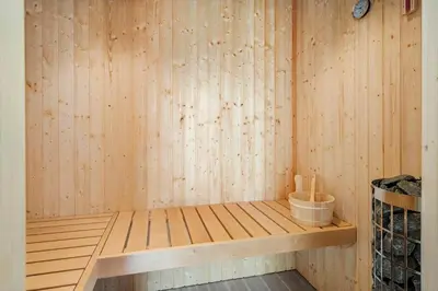 a sauna with a wooden wall and a wooden shelf at 375-Harboore-Gloryvej-14-A in Harboør