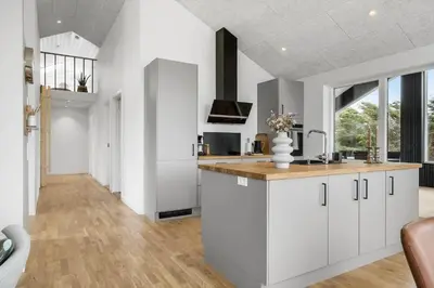 a kitchen with white cabinets and a counter top at 375-Harboore-Gloryvej-14-A in Harboør