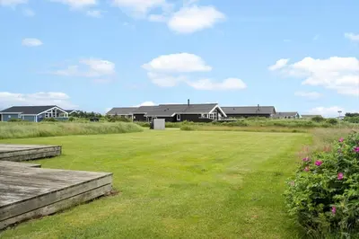 a large yard with houses in the background at 187-Harboore-Neerlandiavej-1 in Harboør