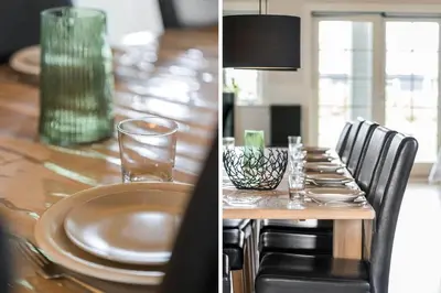 a dining room table with plates and glasses on it at 187-Harboore-Neerlandiavej-1 in Harboør