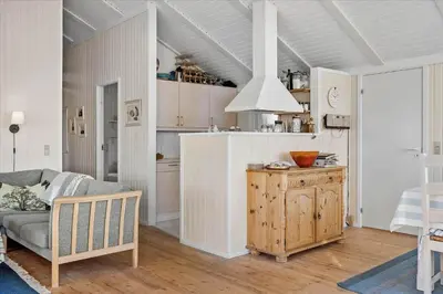 a living room with a couch and a kitchen at 248-Harboore-Viktoriavej-16 in Harboør