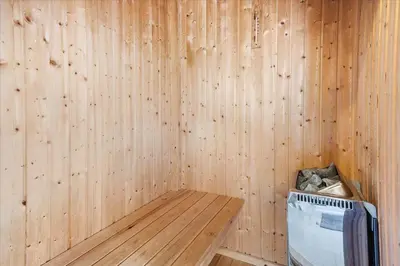 a room with a wooden wall with a trash can at 248-Harboore-Viktoriavej-16 in Harboør