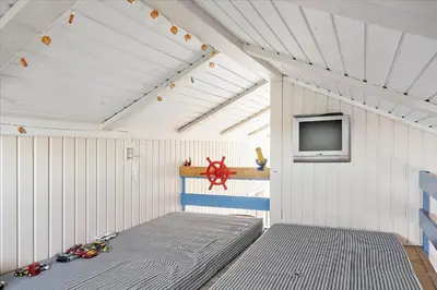 a room with a bed and a tv on a wall at 248-Harboore-Viktoriavej-16 in Harboør