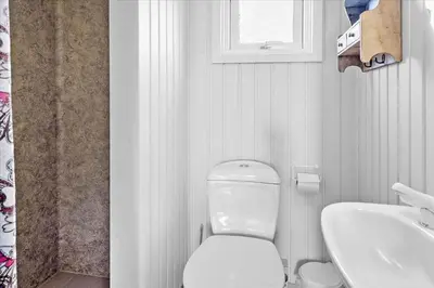 a white bathroom with a toilet and a sink at 248-Harboore-Viktoriavej-16 in Harboør