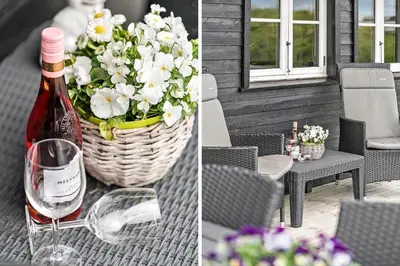 a bottle of wine sitting on a table with a basket of flowers at G305-Lemvig-Porsevej-105 in Lemvig