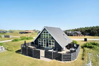 a black house with a gambrel roof on a field at 226-Harboore-Nautilusvej-5 in Harboør