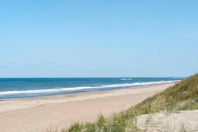 a sandy beach with the ocean in the background at 226-Harboore-Nautilusvej-5 in Harboør
