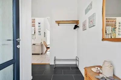 a hallway with a door and a table in a room at G193-Lemvig-Bellisvej-93 in Lemvig