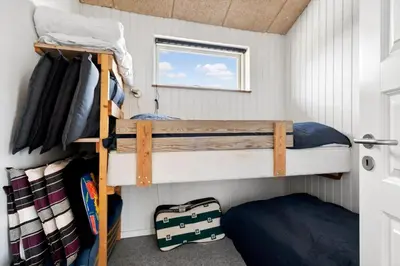 two bunk beds in a small room with a window at G193-Lemvig-Bellisvej-93 in Lemvig