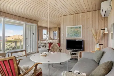 a living room with a couch and a table at 218-Harboore-Dalevej-6-a in Harboør