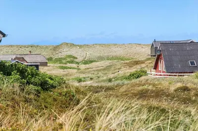 a house on the side of a grassy hill at 218-Harboore-Dalevej-6-a in Harboør