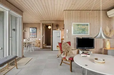 a living room with a table and a tv at 218-Harboore-Dalevej-6-a in Harboør