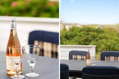 a bottle of champagne and two wine glasses on a table at 323-Harboore-Skalvej-4-a in Harboør