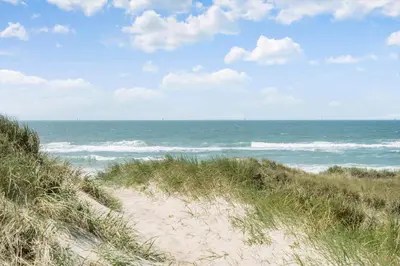a sandy beach with the ocean in the background at 323-Harboore-Skalvej-4-a in Harboør