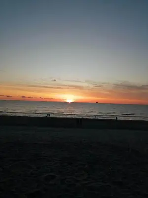 a sunset on a beach with the ocean at 323-Harboore-Skalvej-4-a in Harboør