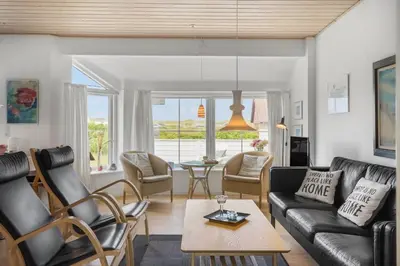 a living room with a couch and chairs and a table at 323-Harboore-Skalvej-4-a in Harboør