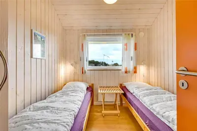 two beds in a small room with a window at G131-Lemvig-Skovstjernevej-31 in Lemvig