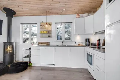 a white kitchen with white cabinets and windows at G107-Lemvig-Sogardevejen-7 in Lemvig
