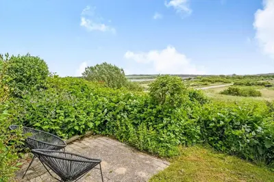 a couple of chairs sitting next to a bush at G107-Lemvig-Sogardevejen-7 in Lemvig