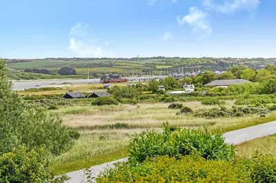 a train traveling down a road next to a field at G107-Lemvig-Sogardevejen-7 in Lemvig
