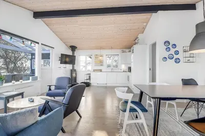 a living room with blue chairs and a table at G107-Lemvig-Sogardevejen-7 in Lemvig