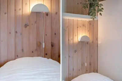 a bedroom with a wood paneled wall and a bed at 119-Harboore-Neerlandiavej-32 in Harboør