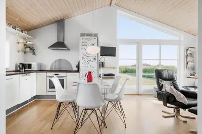 a kitchen with a table and chairs in a room at G119-Lemvig-Klovervej-19 in Lemvig