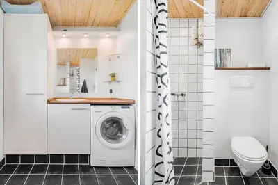 a laundry room with a washer and dryer in a bathroom at G119-Lemvig-Klovervej-19 in Lemvig
