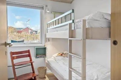 a small room with a bunk bed and a window at G281-Lemvig-Syrenvej-81 in Lemvig