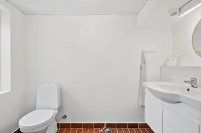 a white bathroom with a toilet and a sink at 369-Lemvig-Klostervej-39 in Lemvig
