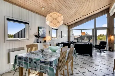 a dining room with a table and chairs at 102-Harboore-Vejlby-Klit-21 in Harboør