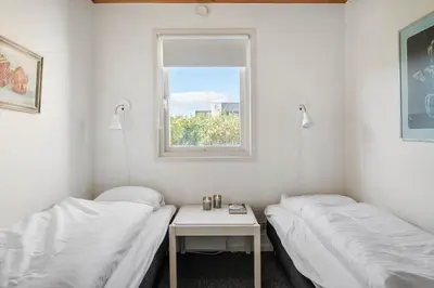 two beds in a room with a window at G147-Lemvig-Syrenvej-47 in Lemvig