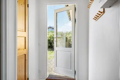 an open door with a view of a yard at G147-Lemvig-Syrenvej-47 in Lemvig