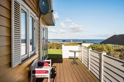 a balcony with a table and a view of the ocean at G147-Lemvig-Syrenvej-47 in Lemvig