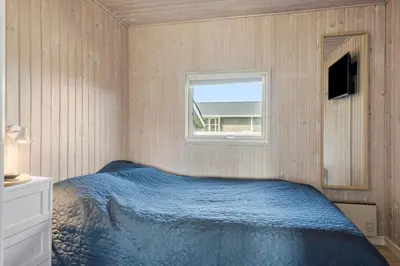 a bedroom with a bed and a window at 801-Harboore-Vejlby-Klit-89 in Harboør
