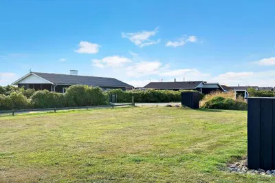 a large yard with houses in the background at 801-Harboore-Vejlby-Klit-89 in Harboør