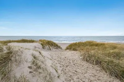 a sandy path leading to a beach with the ocean at 801-Harboore-Vejlby-Klit-89 in Harboør