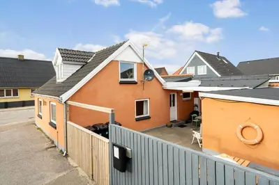 a house with a fence in front of it at 725-Thyboron-Vesterhavsgade-111 in Thyborøn