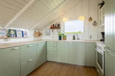 a kitchen with white cabinets and a window at 804-Harboore-Neerlandiavej-214 in Harboør
