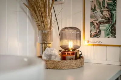 a table with a candle and a vase with a light at 804-Harboore-Neerlandiavej-214 in Harboør