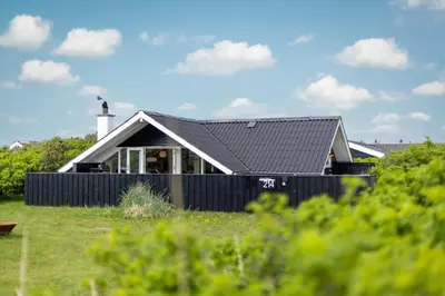 a house with a black fence in front of it at 804-Harboore-Neerlandiavej-214 in Harboør